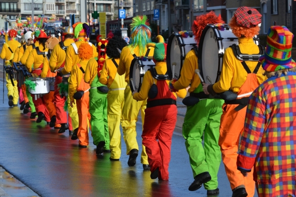 Karnevalsumzüge in Jülich Bild: Eine Musikgruppe läuft hintereinander in Clownskostümen eine Straße entlang. Sie sind nur von hinten zu sehen.